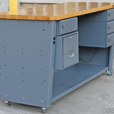 industrial steel base butcher block top workbench by Equipto with extra power outlets and storage 