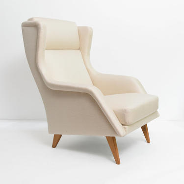 Sleek Scandinavian lounge chair with splayed legs.