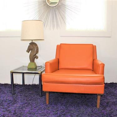 Mid Century Modern beautiful vintage orange vinyl chair in the style of Milo Baughman 
