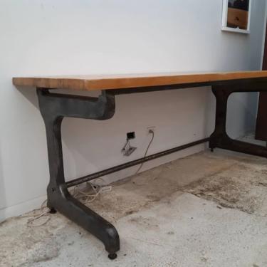 Vintage industrial factory table with maple top and cast iron base. 