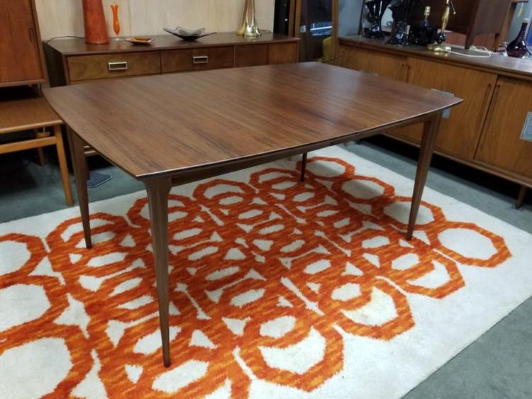                   Mid-Century Modern walnut boat shaped dining table with two 12"leaves