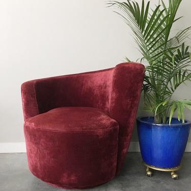 asymmetrical nautilus swivel chair in red velvet.