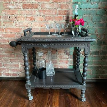 Antique rolling two-tier bar cart with removable glass-top serving tray