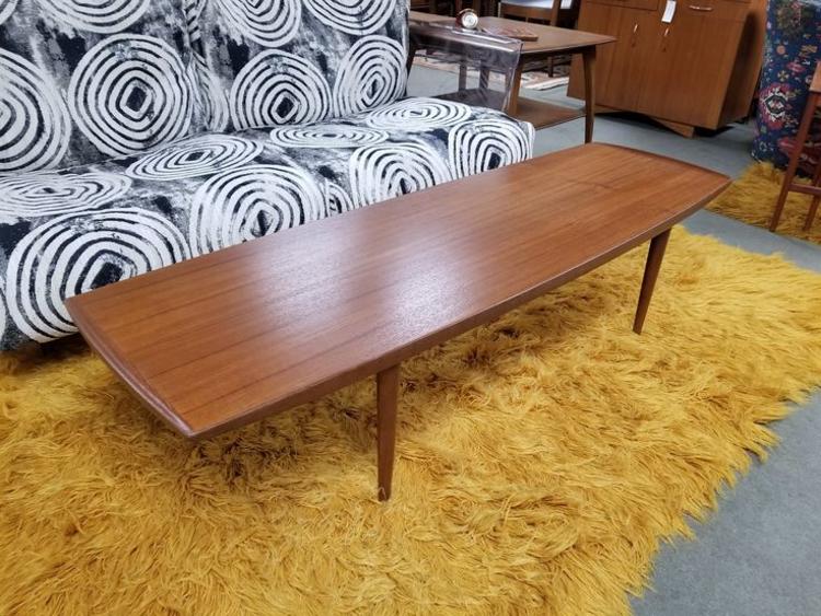                   Danish Modern teak surfboard coffee table with curved edges