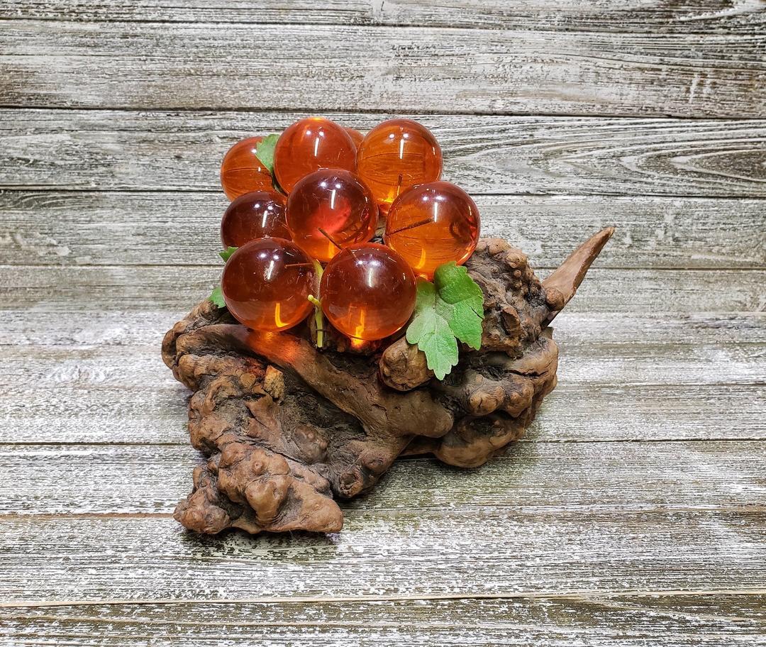 Amber lucite grapes on driftwood
